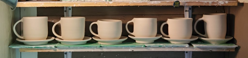 greenware porcelain mugs in a row