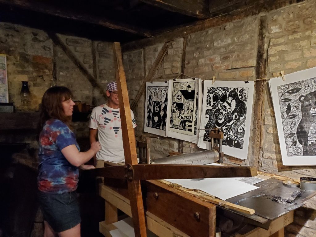 artists alycia larsen and dustin cecil printing at the log cabin print shop