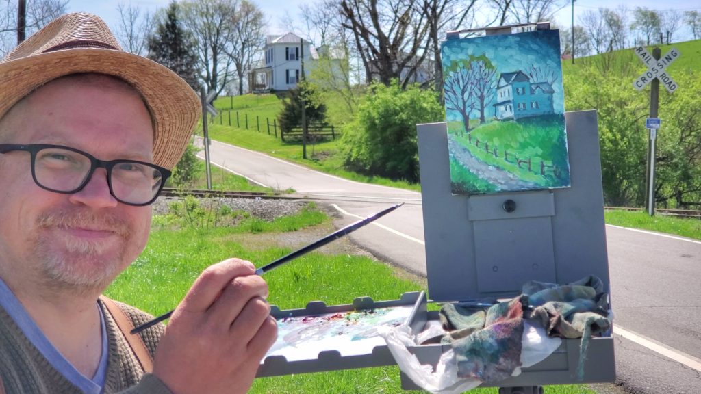 kentucky artist ken swinson painting at strodes run in mason county. the view is a house on a hill from a railroad track