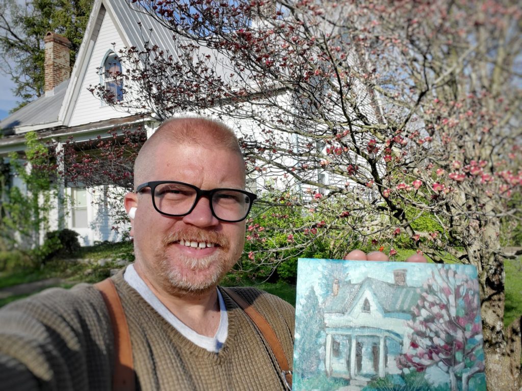 artist standing in front of house with plein air painting in Old Washington, Kentucky