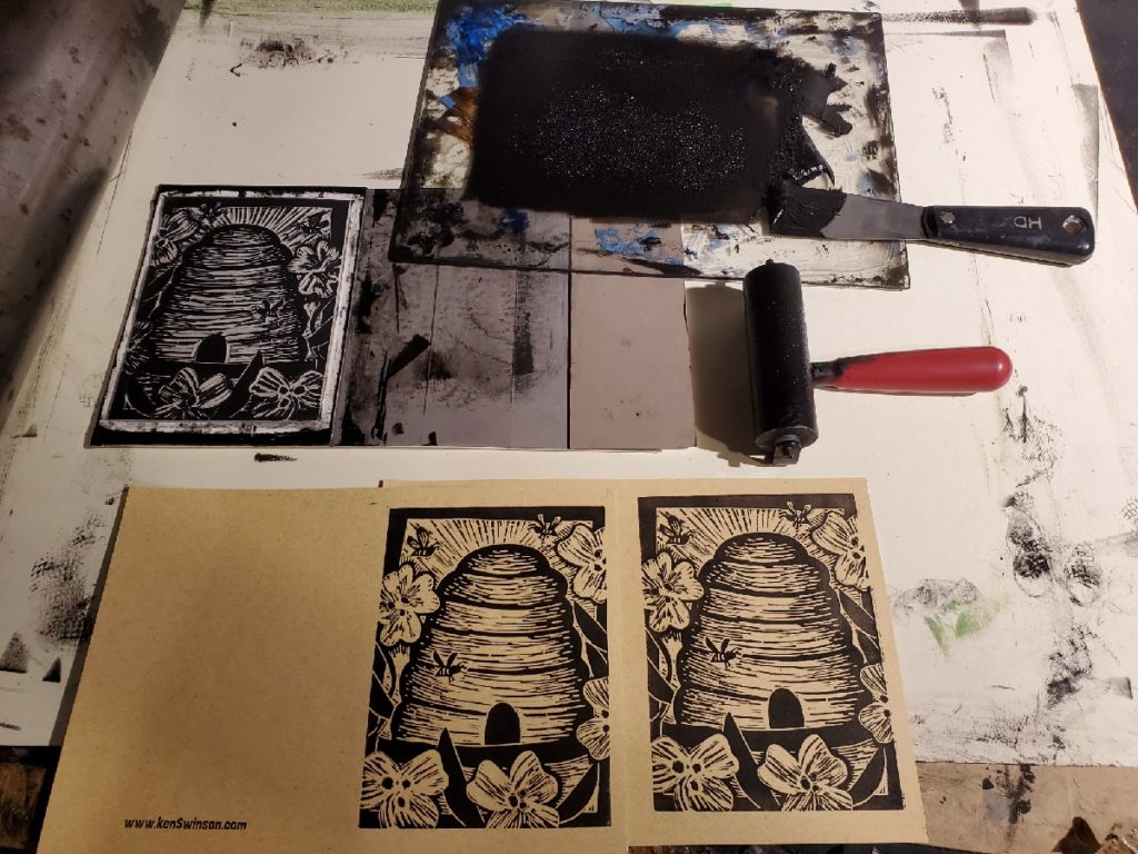 test proof of beehive linocut. ink and brayer visible in photo