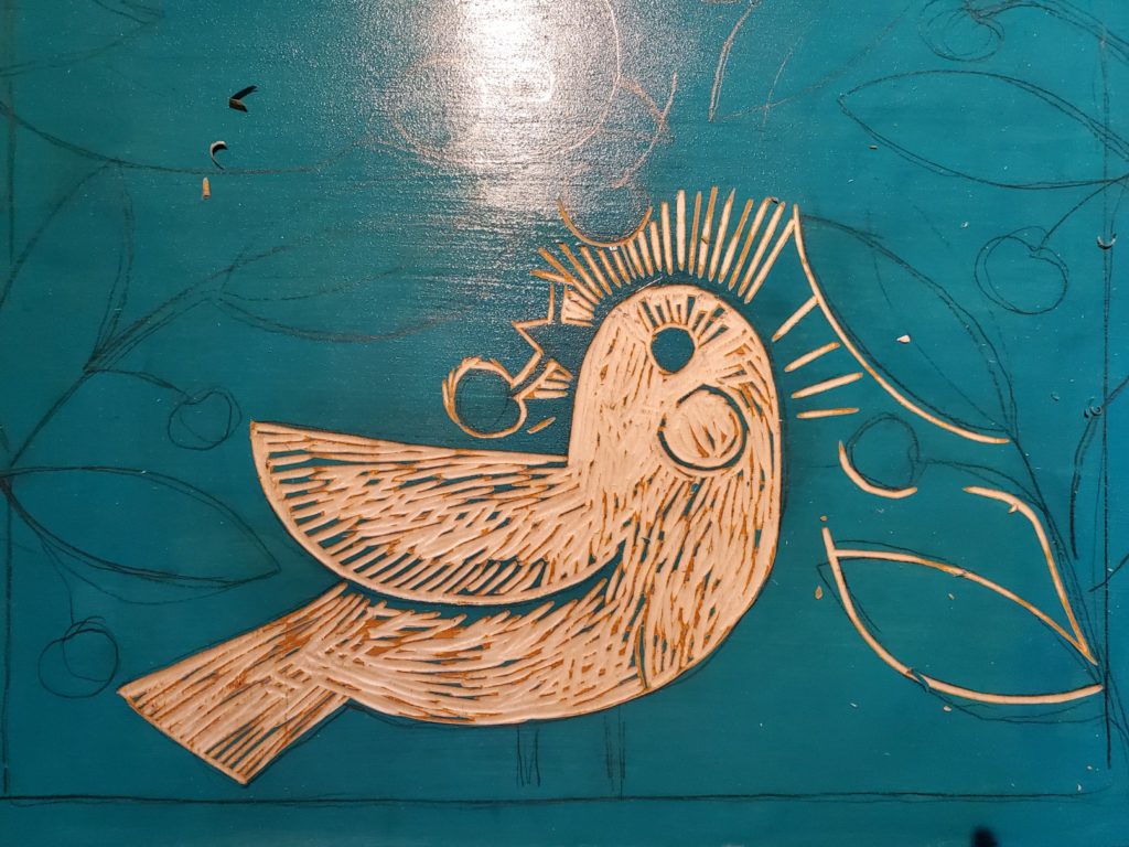 first cuts of a woodcut of bird with cherry