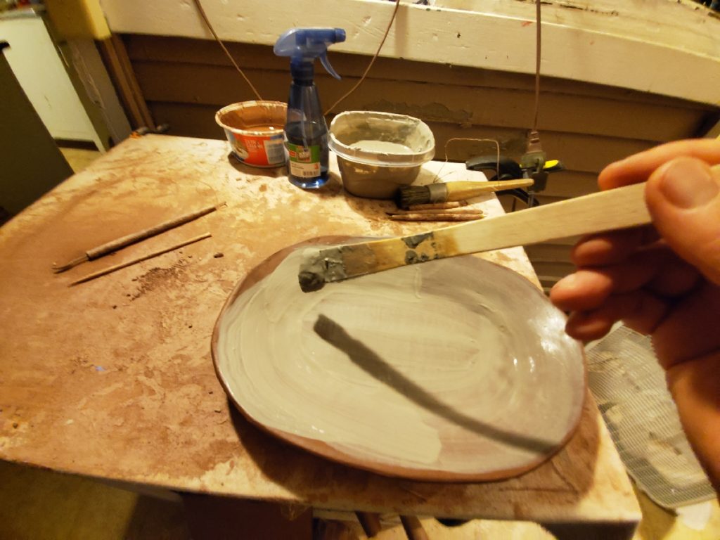 painting slip over redware plate