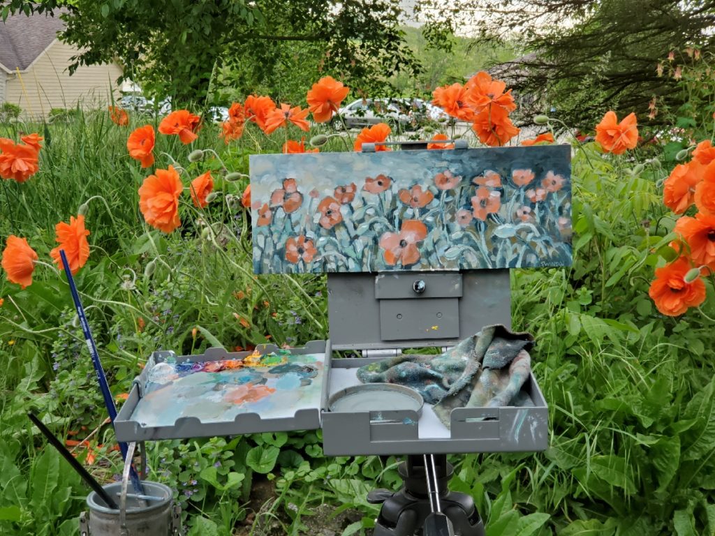 plein air painting of poppies with photo of bright red poppies in the background by artist ken swinson