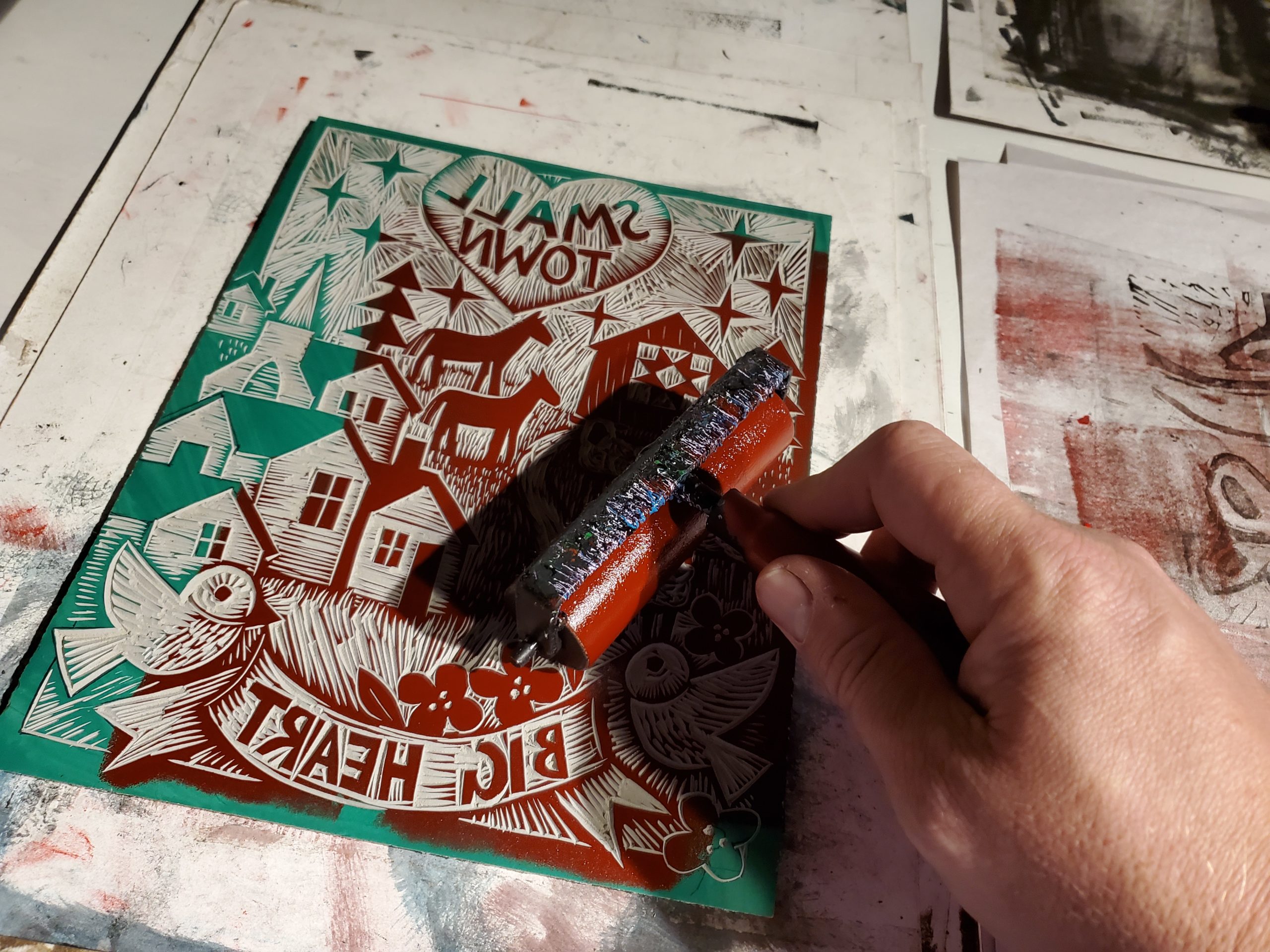 photo of ink being rolled over a linocut