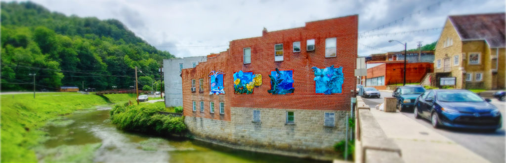 photo of public art on building beside creek in whitesburg kentucky