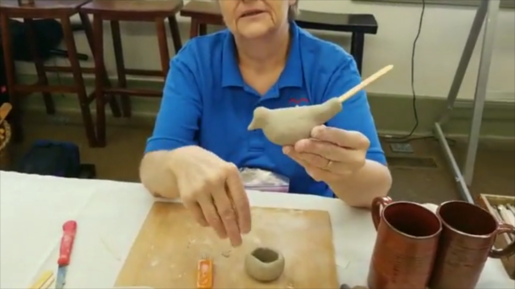 woman making a clay whistle in old washington kentucky