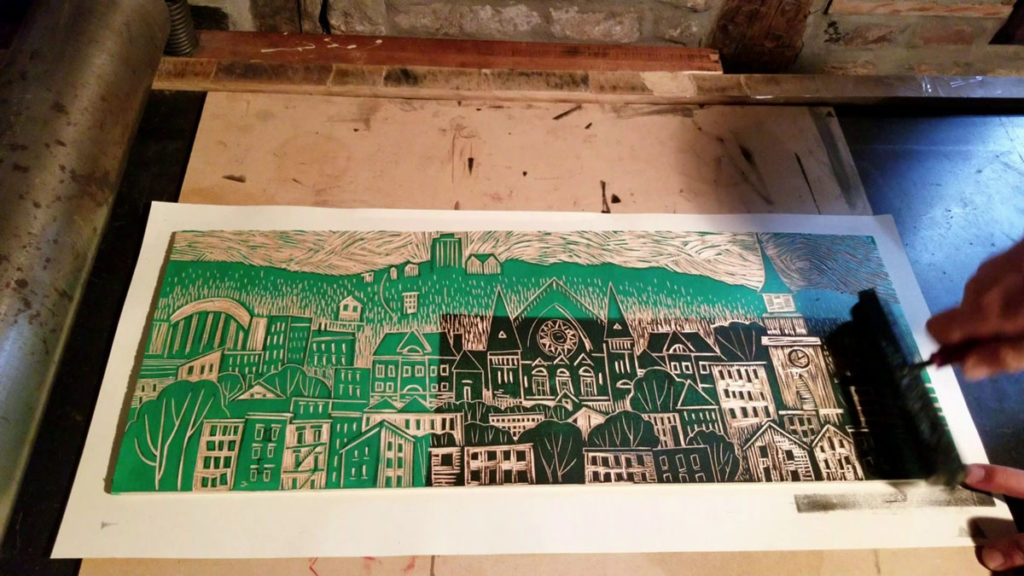 rolling ink on a traditional woodcut block print of Cincinnati's neighborhood Over The Rhine