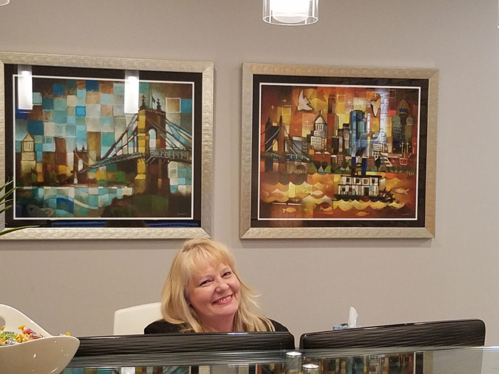 artist ken swinson paintings of  cincinnati framed and on display at reception desk