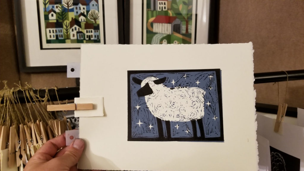 hand holding 2 color sheep linocut