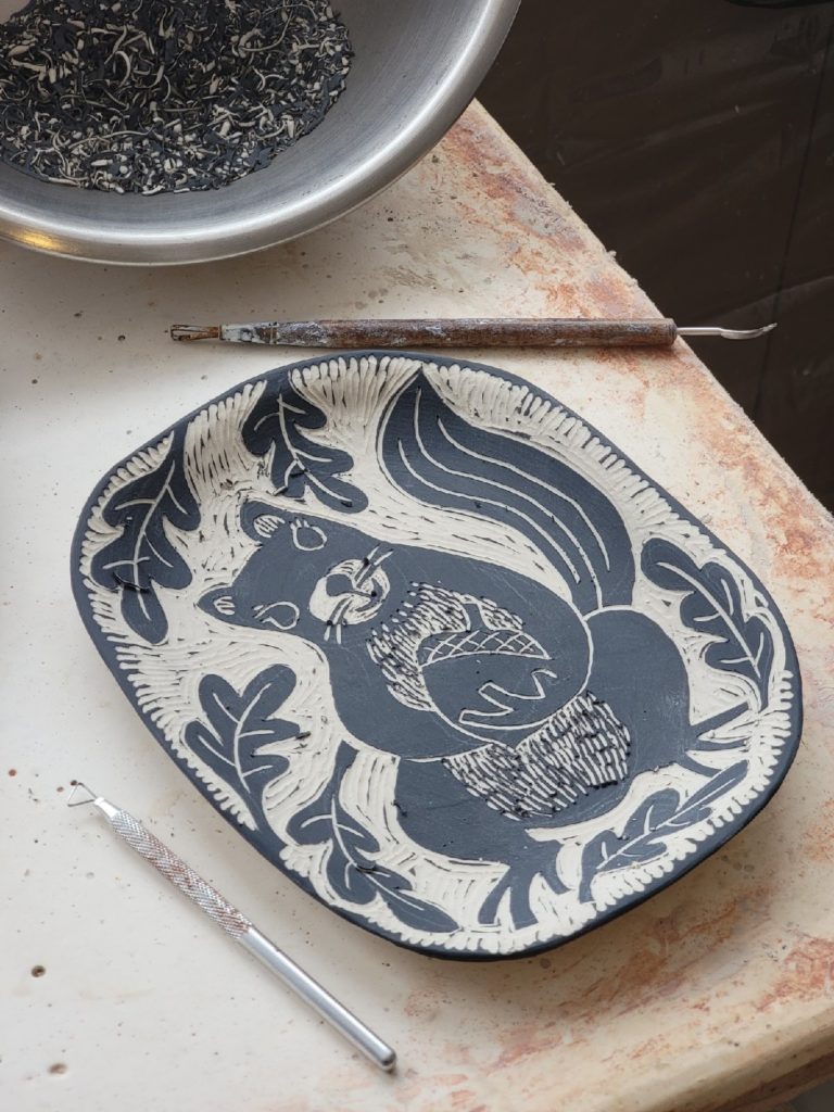 Sgraffito plate with squirrel and acorn decoration porcelain