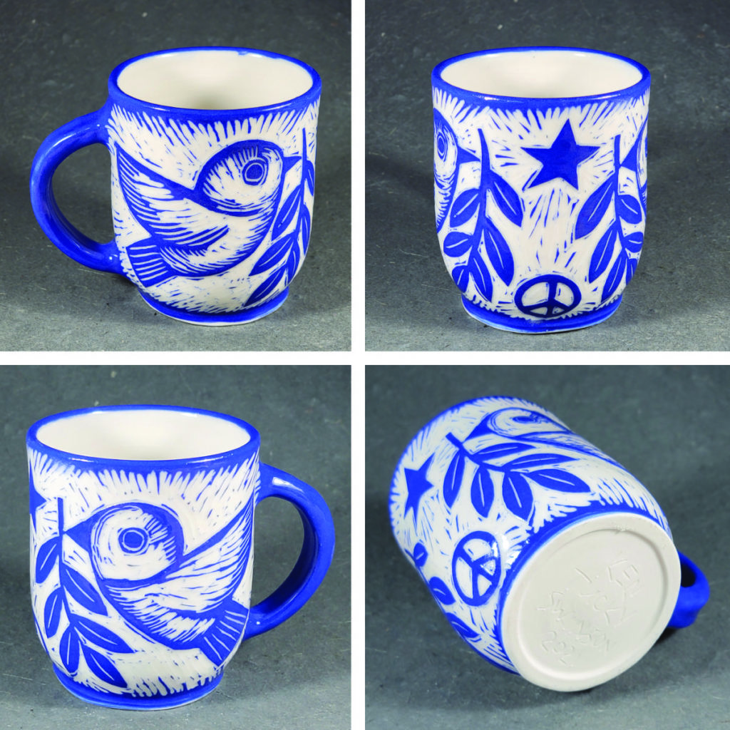 porcelain mug with blue design of birds carrying olive branch and peace symbol