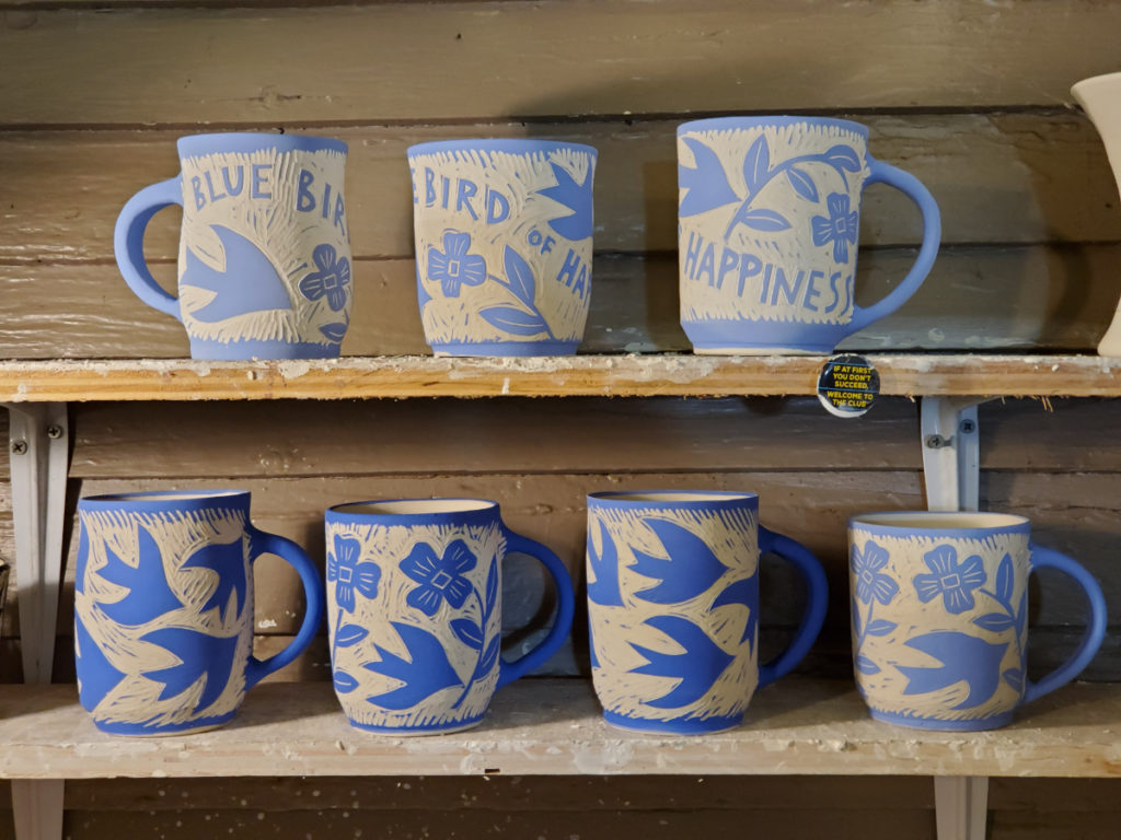 greenware porcelain cups with blue slip and sgraffito design of bluebirds and flowers