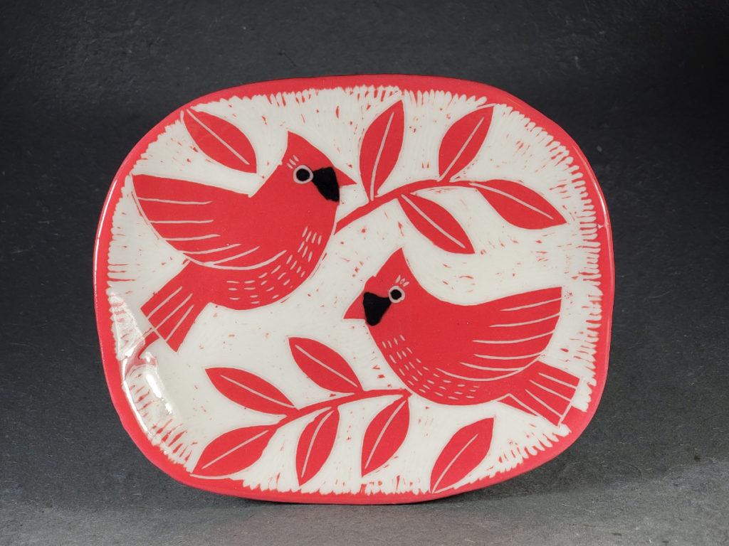 red porcelain plate with cardinal design