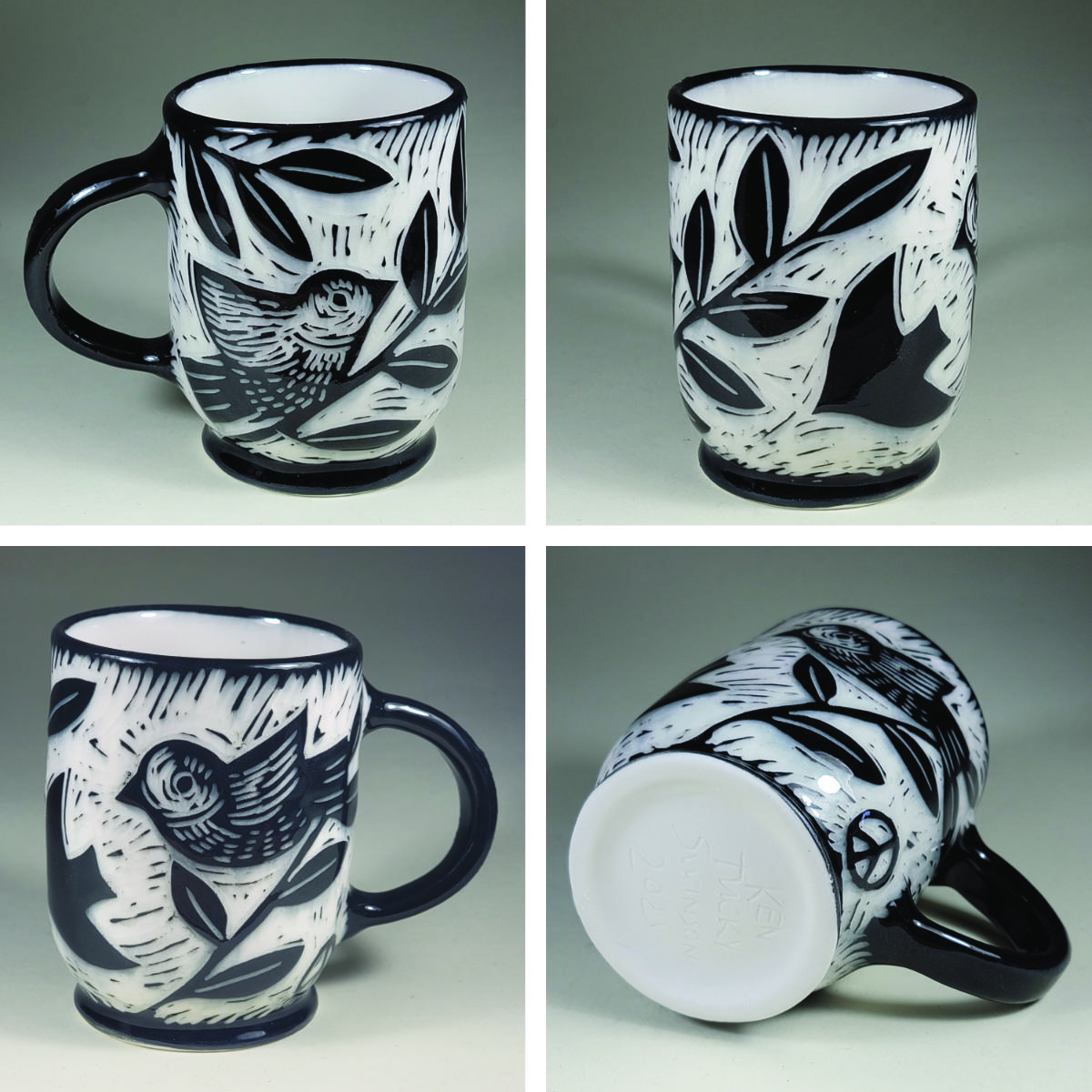 porcelain cup with birds and peace symbols sgrafito design black