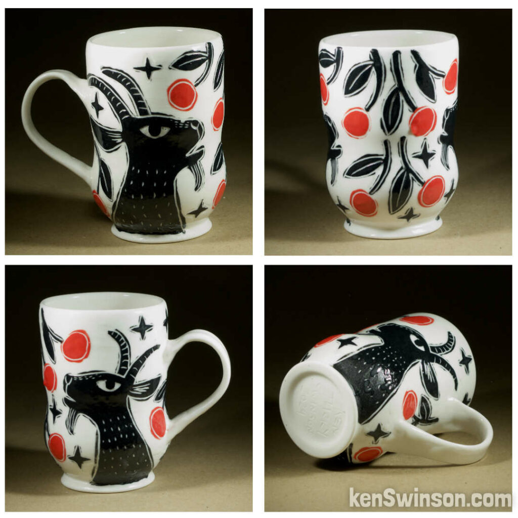 A wheel thrown porcelain cappuccino cup made by Kentucky artist, ken swinson-the bowl is decorated with black, white and red sgraffito design of a goat eating cherries.