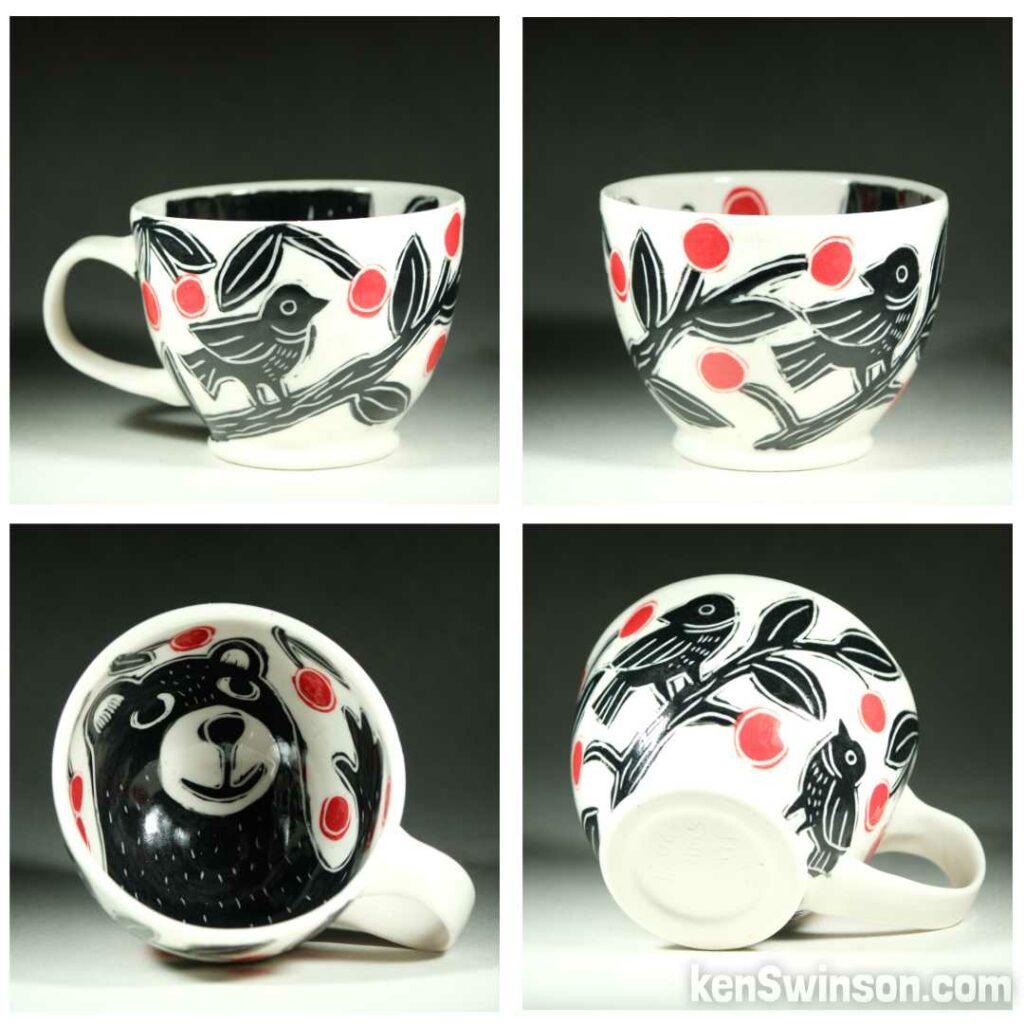 Handmade, wheel thrown porcelain cup by Kentucky artist, Ken Swinson with a birds on the exterior, a bear picking cherries on the interior