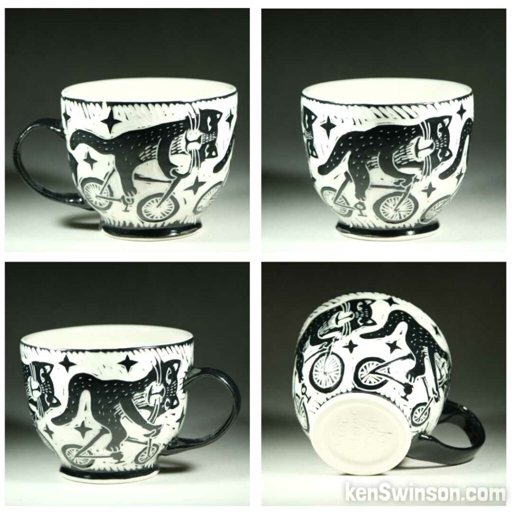 Handmade, wheel thrown porcelain cup by Kentucky artist, Ken Swinson with 3 cats riding bicycles around the cup exterior