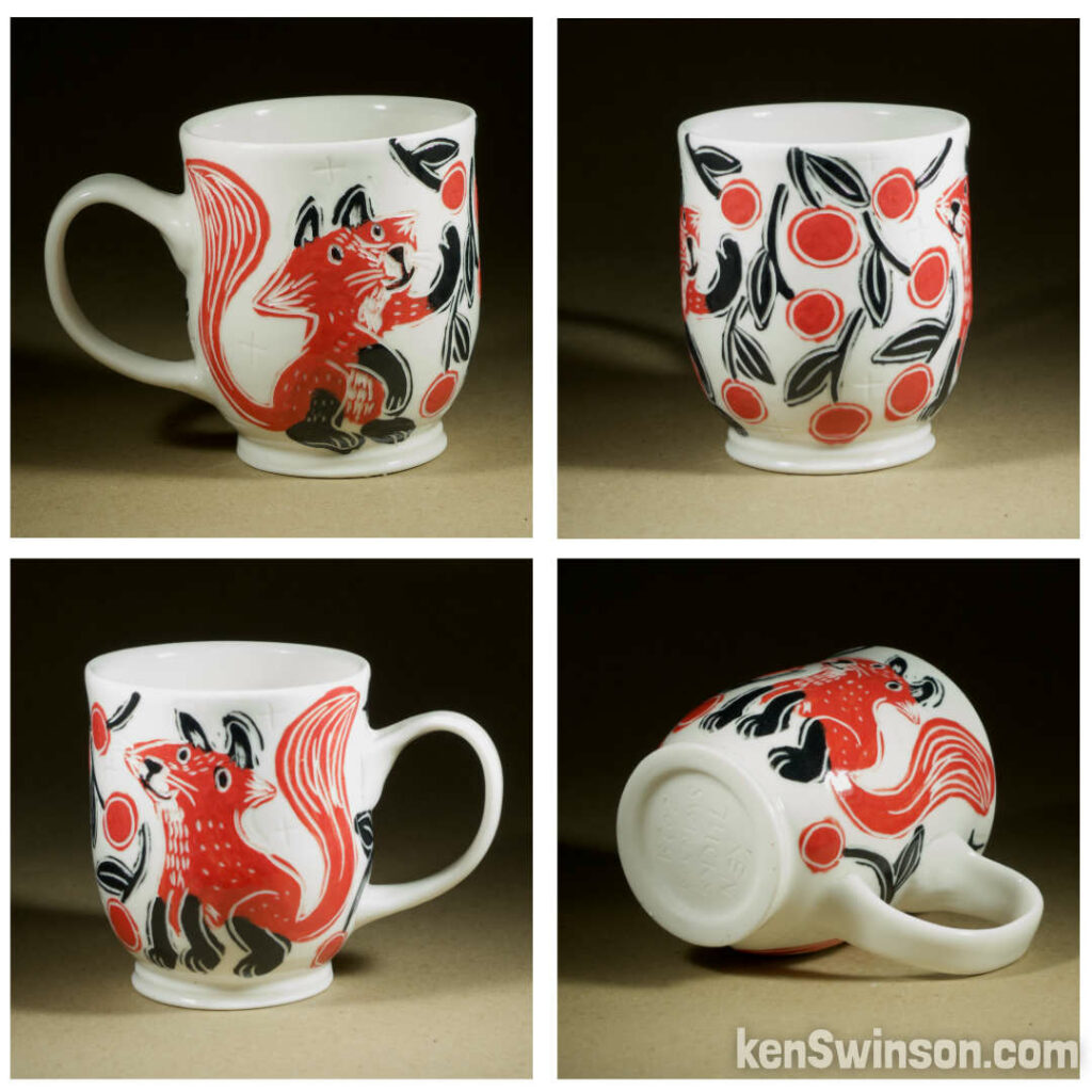 A wheel thrown porcelain cappuccino cup made by Kentucky artist, ken swinson-the bowl is decorated with black, white and red sgraffito design of a fox under a cherry tree.