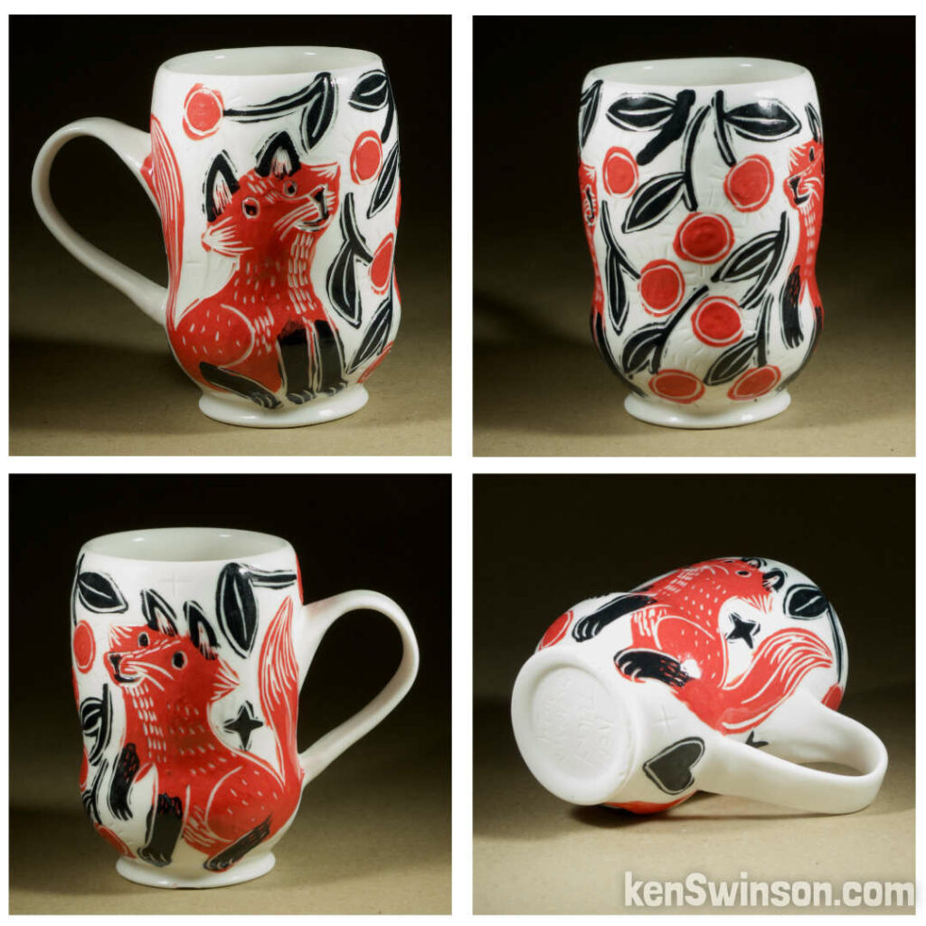 A wheel thrown porcelain cappuccino cup made by Kentucky artist, ken swinson-the bowl is decorated with black, white and red sgraffito design of a fox under a cherry tree.