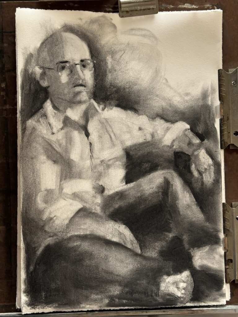 work in progress of a charcoal drawing of a man